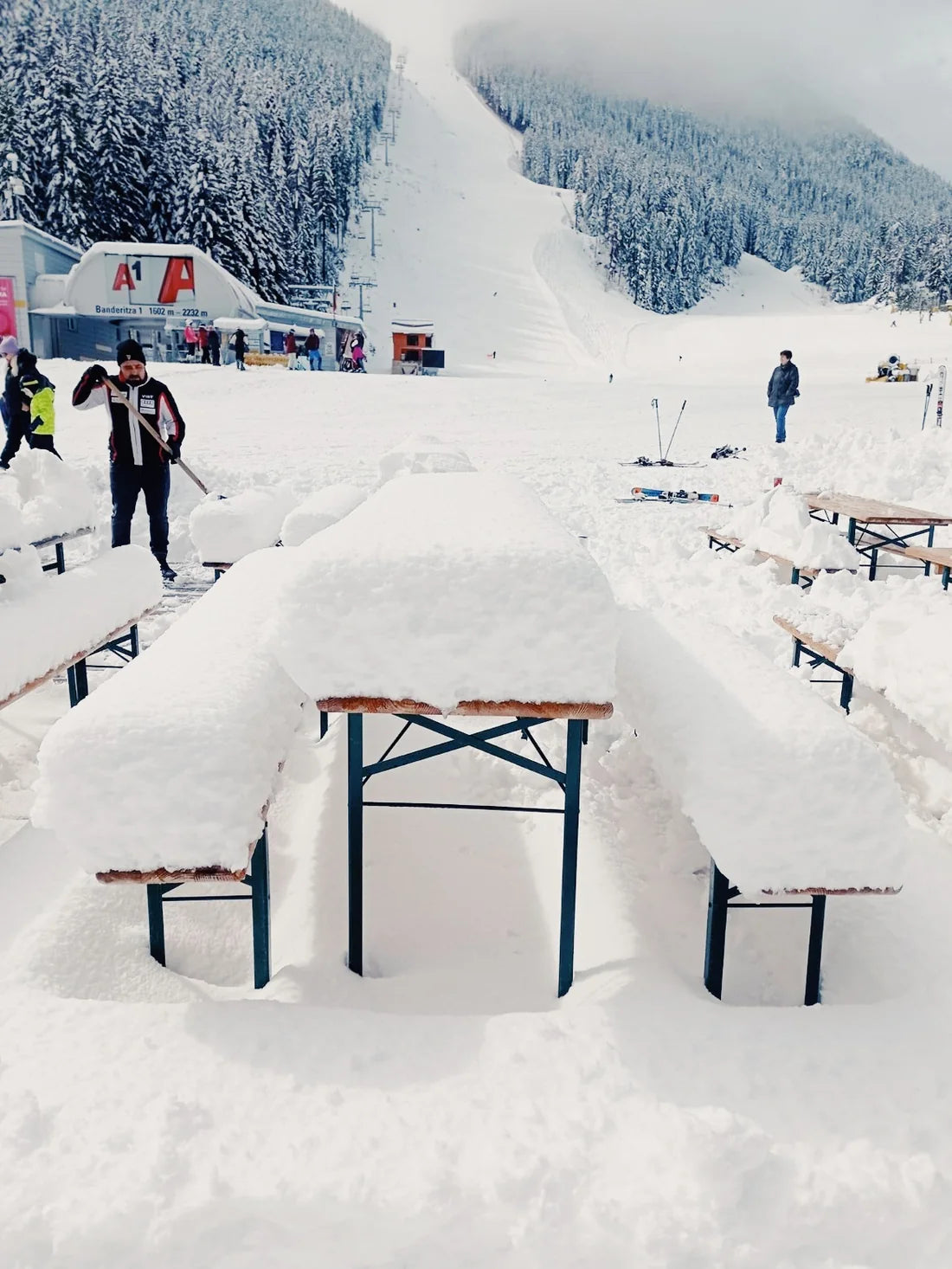 Snow-covered tables and lift area in Bansko